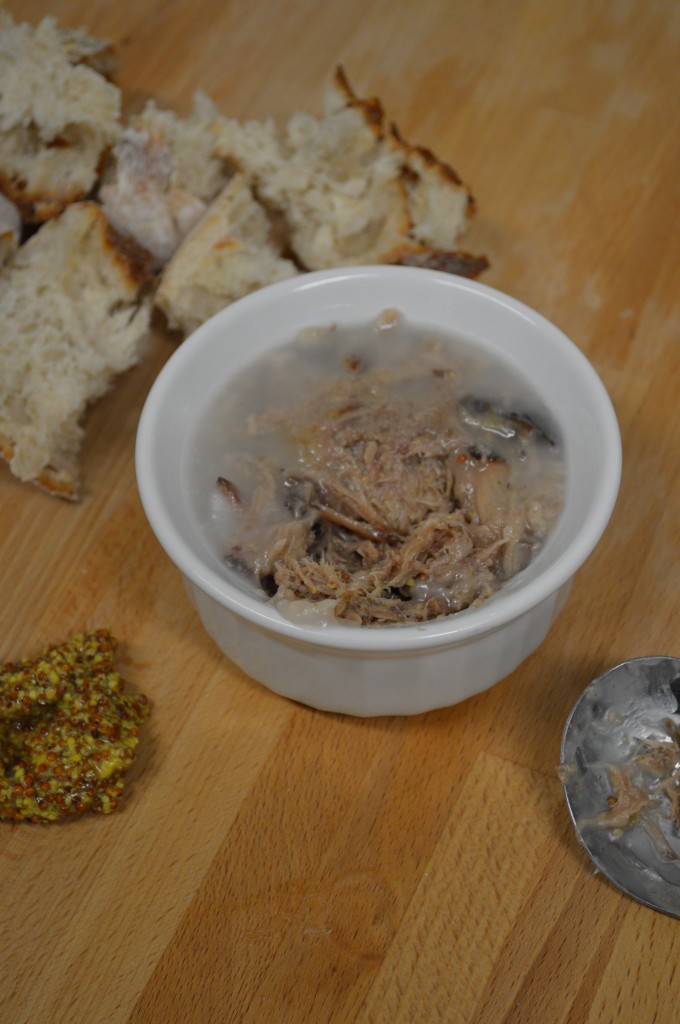 Rillette with bread and mustard on a charcuterie board