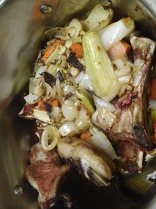 Roast lamb bones and vegetables in a stock pot
