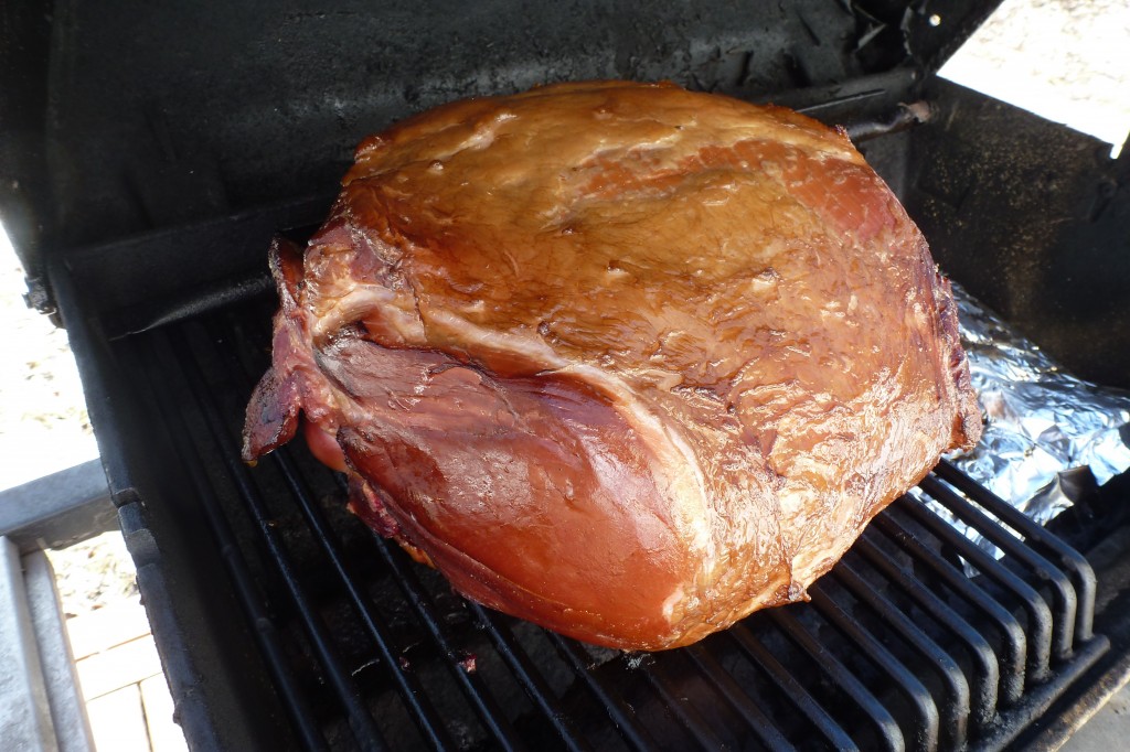 The ham, smoking on the barbecue
