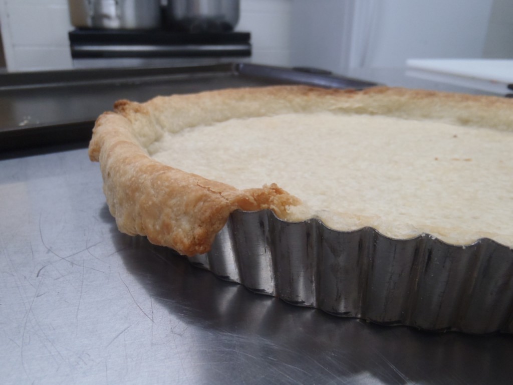 Trimming excess dough from a blind baked tart shell