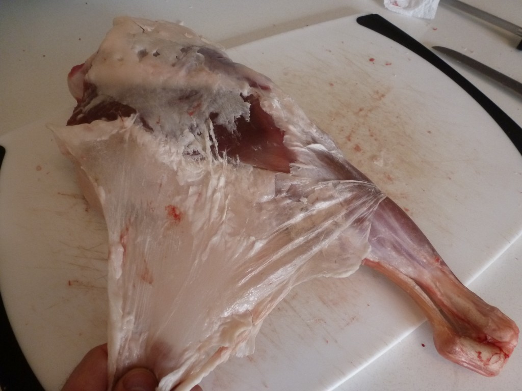 Pulling the fell, a layer of skin, from the lamb leg