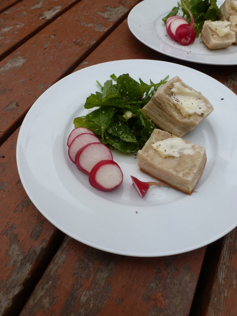 Sliced radish, radish greens, and butter biscuits