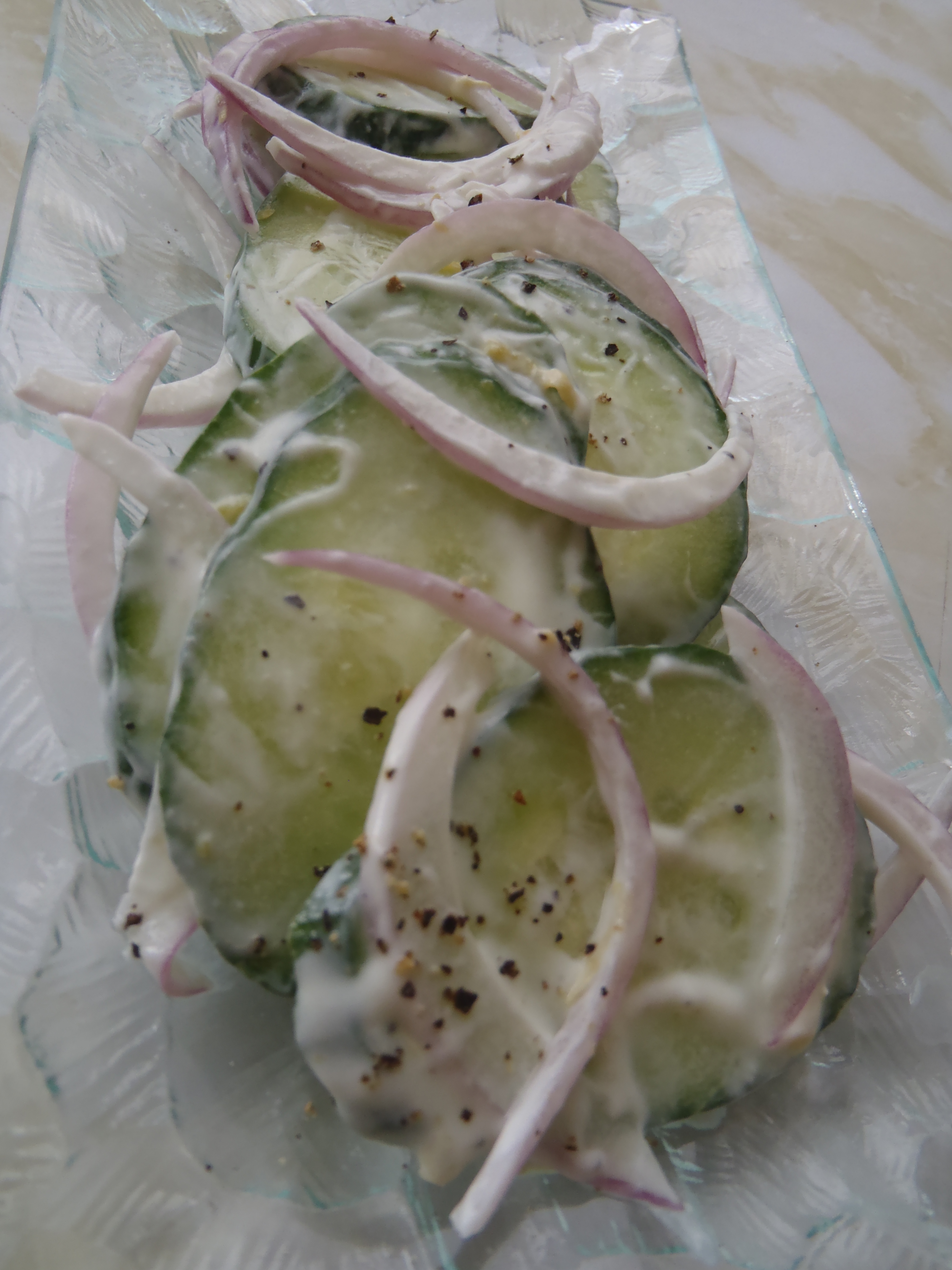 A cucumber salad dressed with lemon ricotta