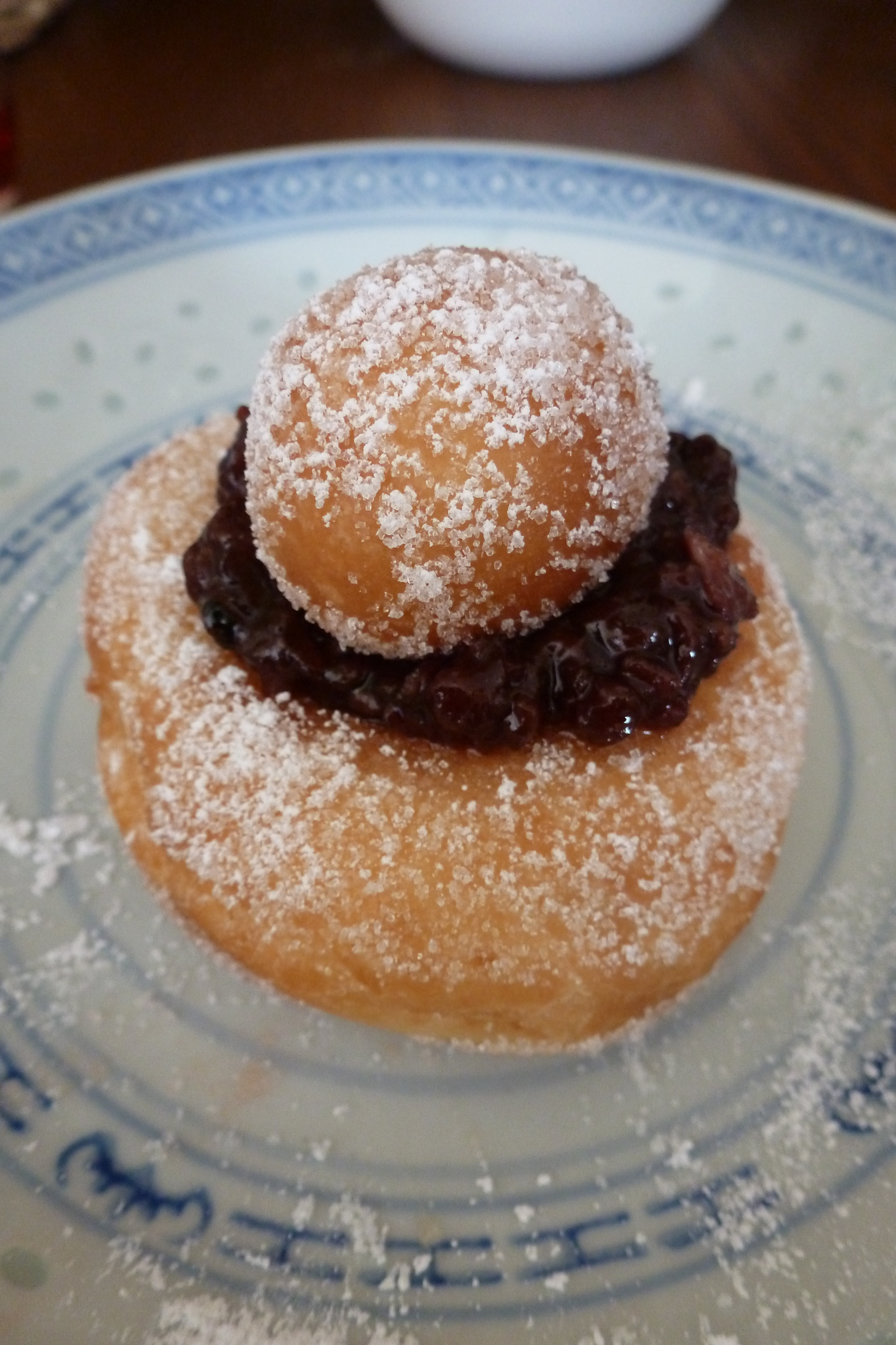 A raised doughnut with raspberry jam