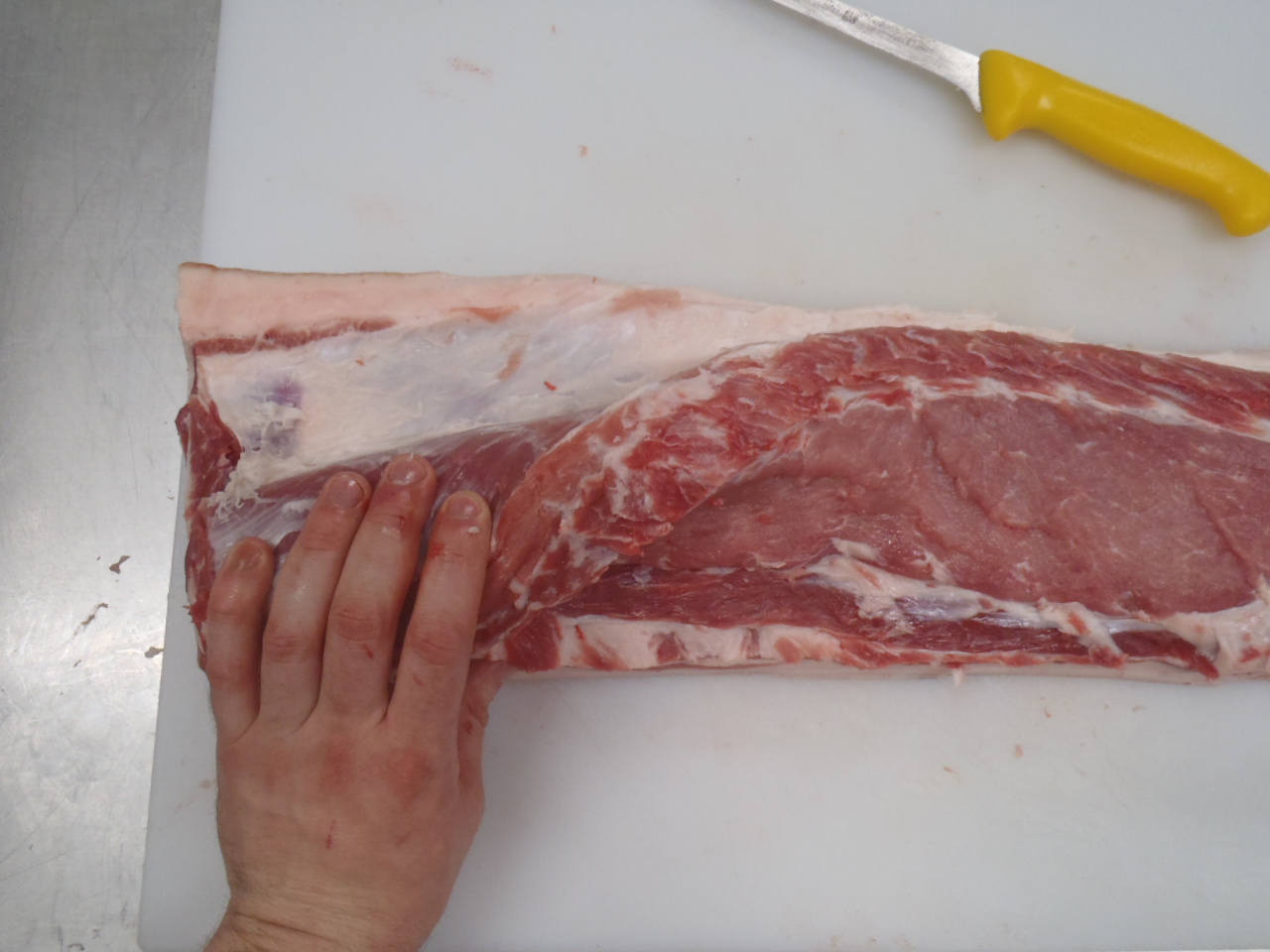 Removing the eye of loin from the fatback