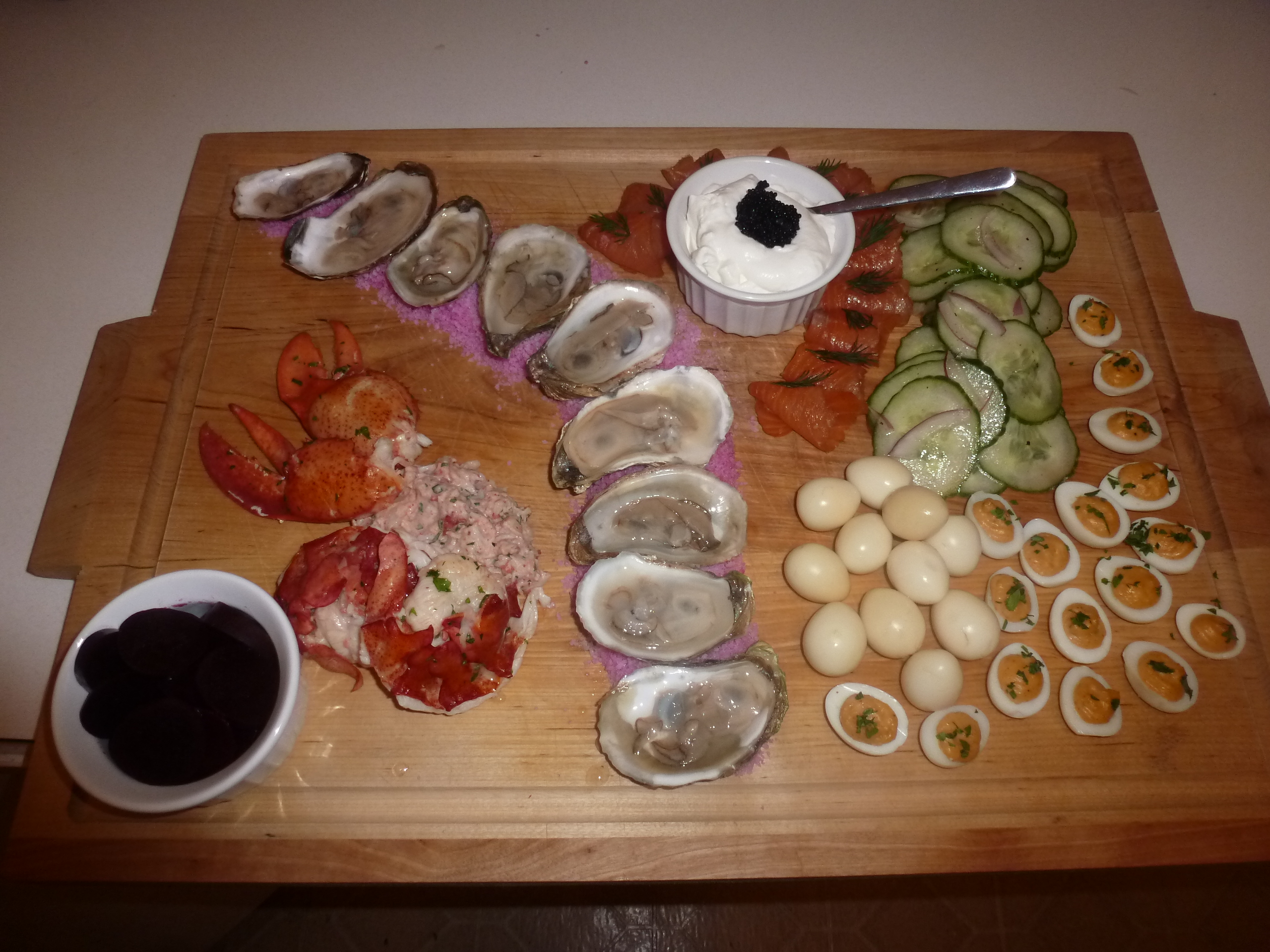 Seafood platter: cold poached lobster, Malpeque oysters, smoked salmon, crème fraîche with caviar, cucumber salad, pickled and devilled quail eggs
