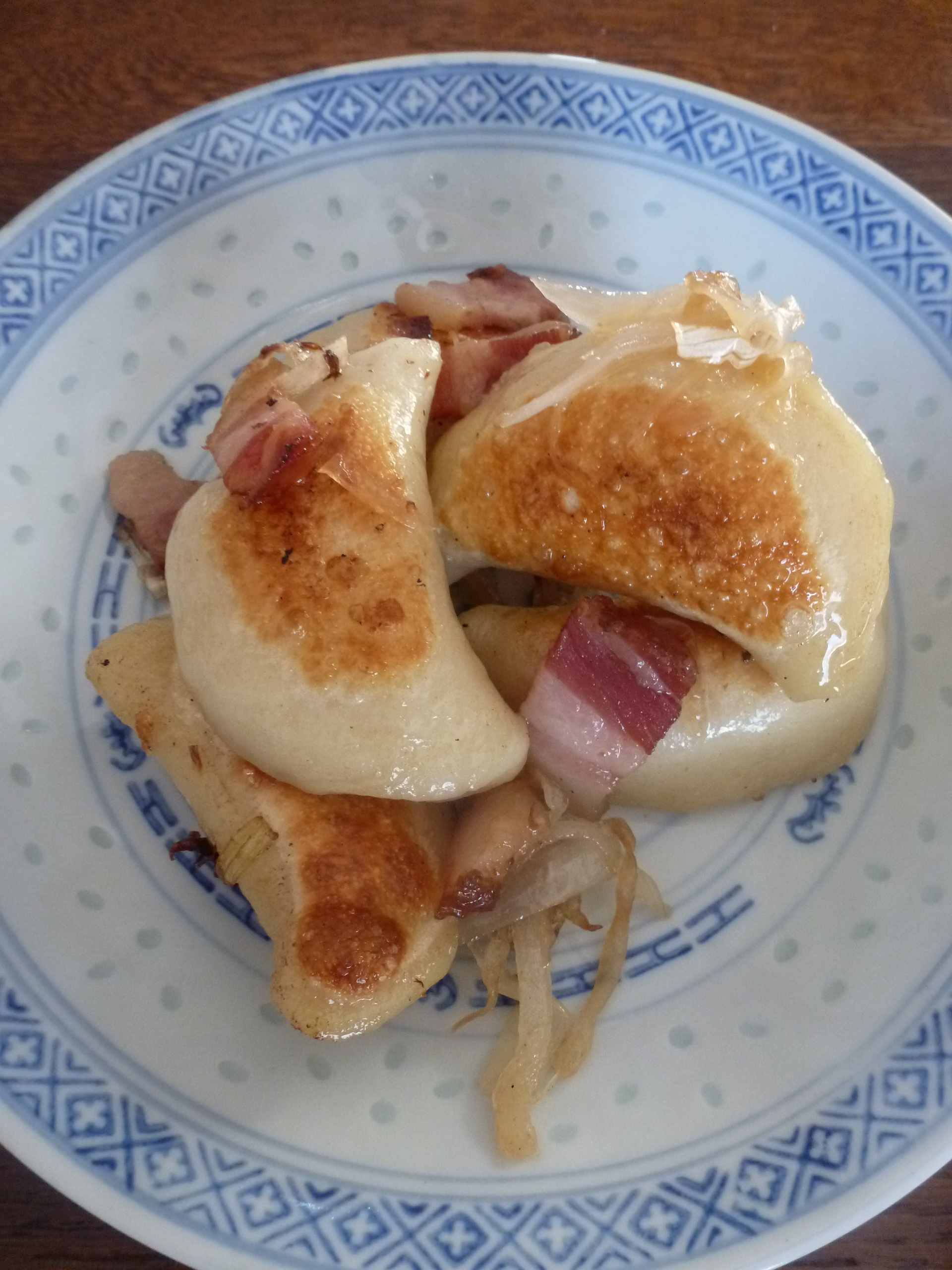 Pan-fried perogies with onions and bacon