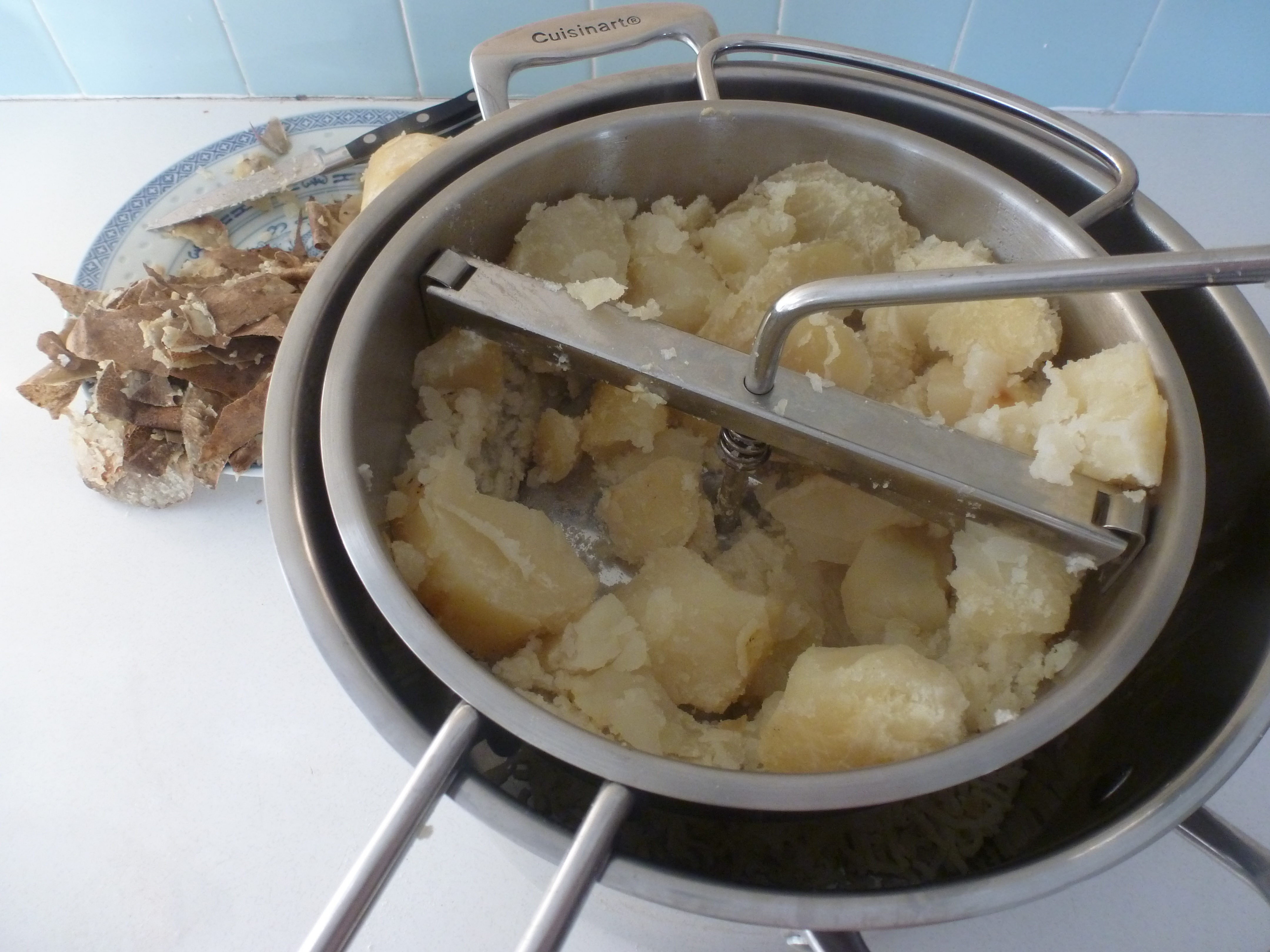 Milling the baked potatoes to make perogies