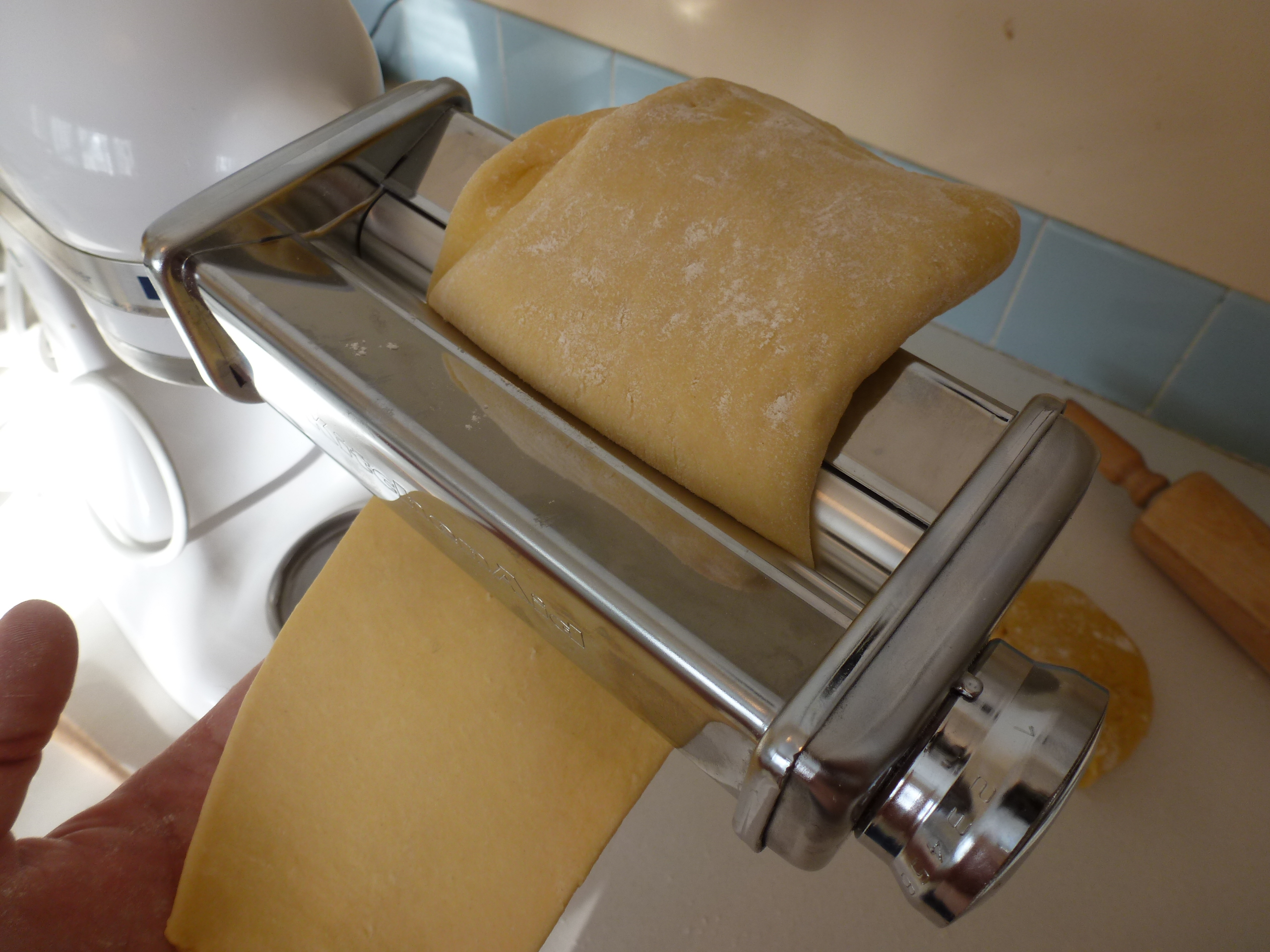 Putting the dough through a roller