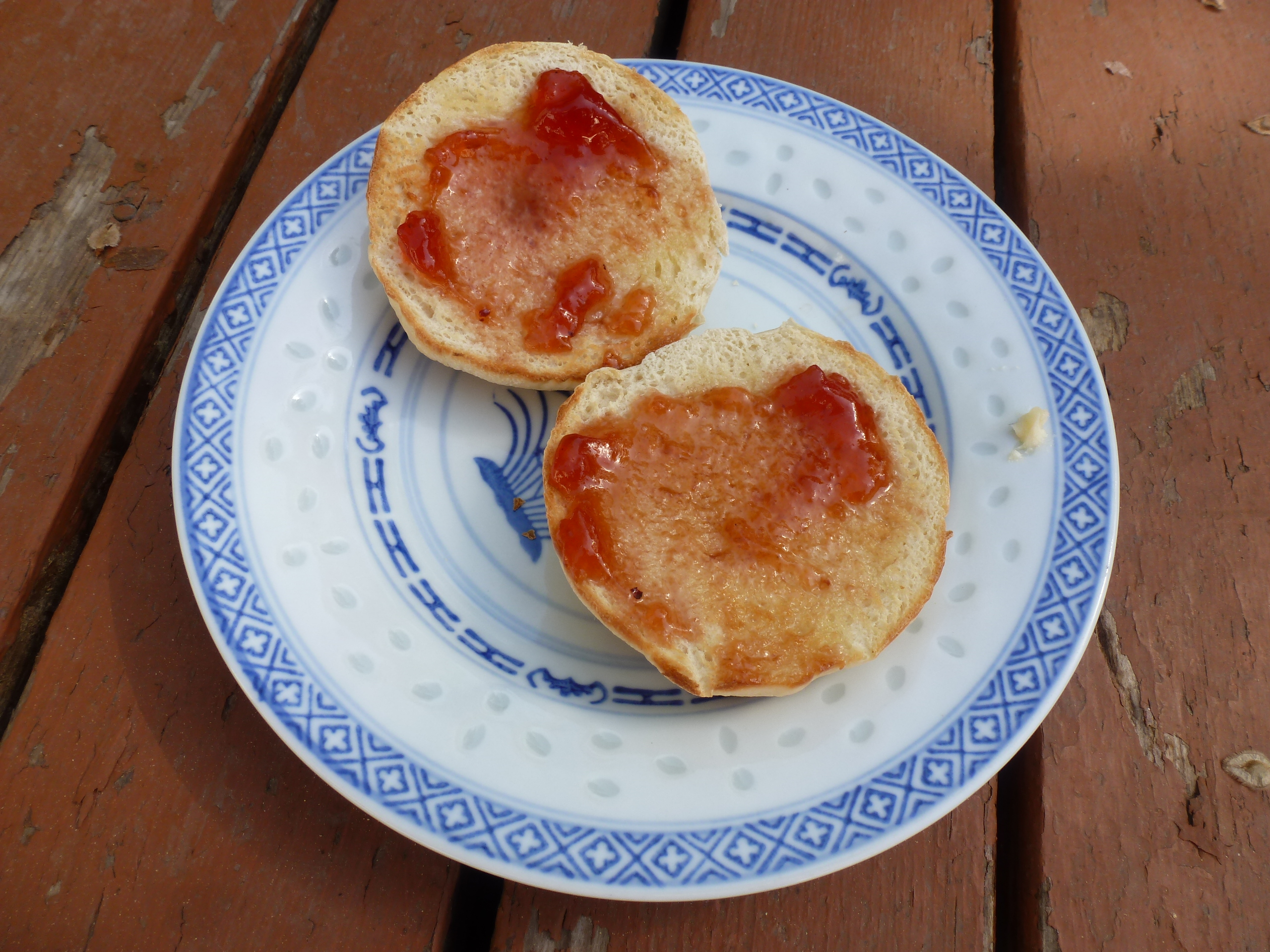Toasted English muffins with butter and cranberry jelly