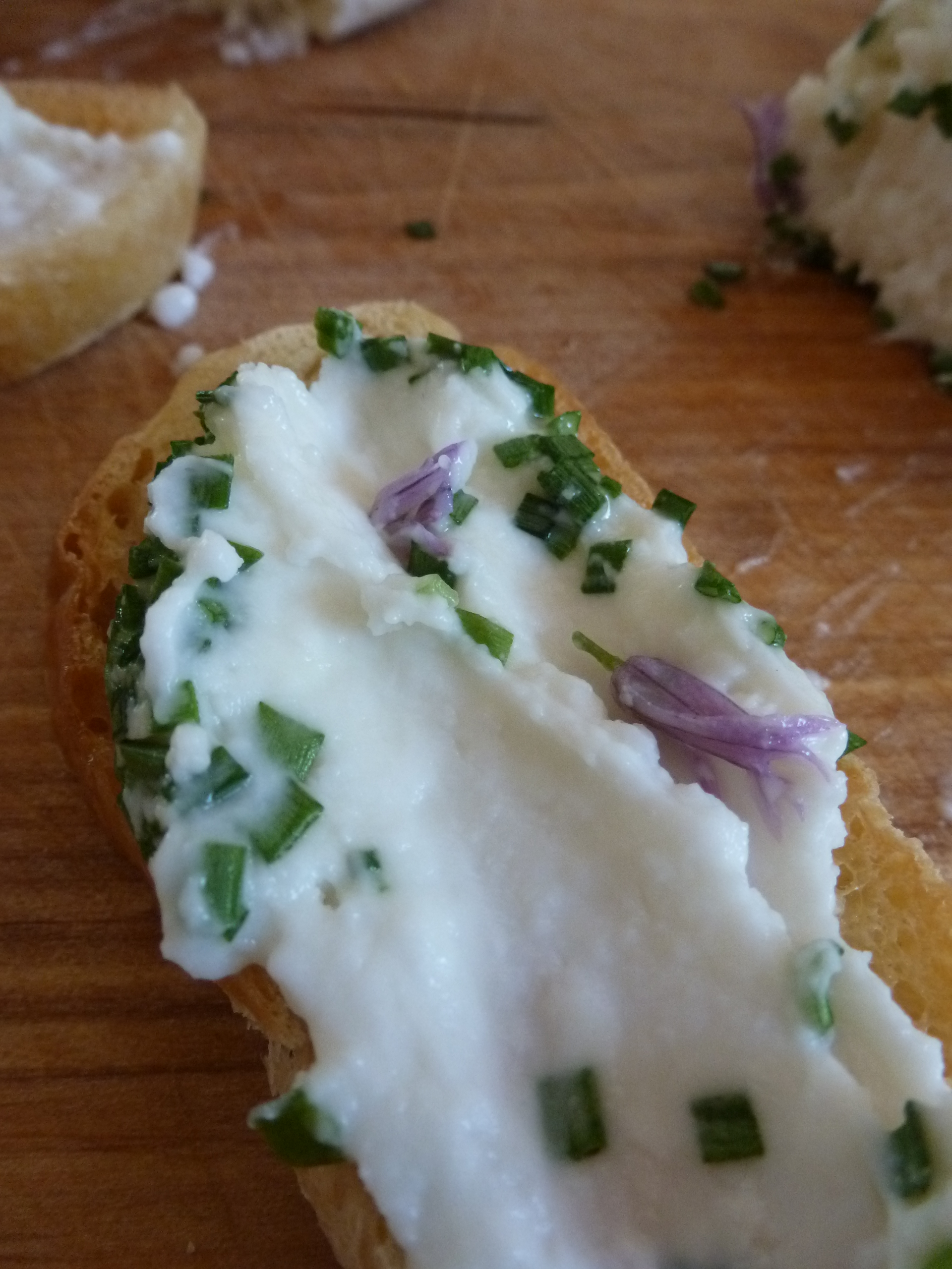 Goat cheese with chive stems and blossoms