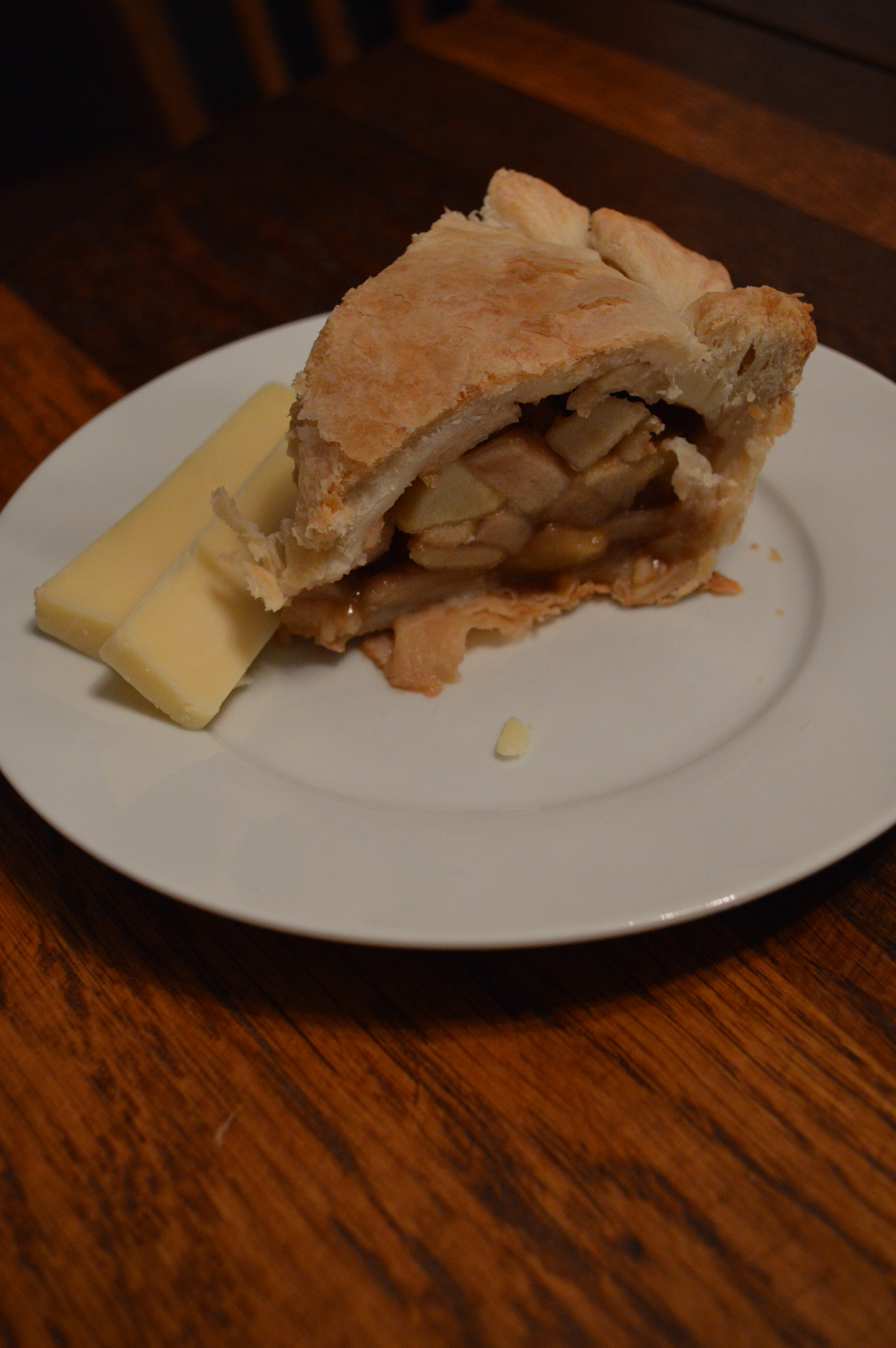 A slice of apple pie with Cheddar cheese