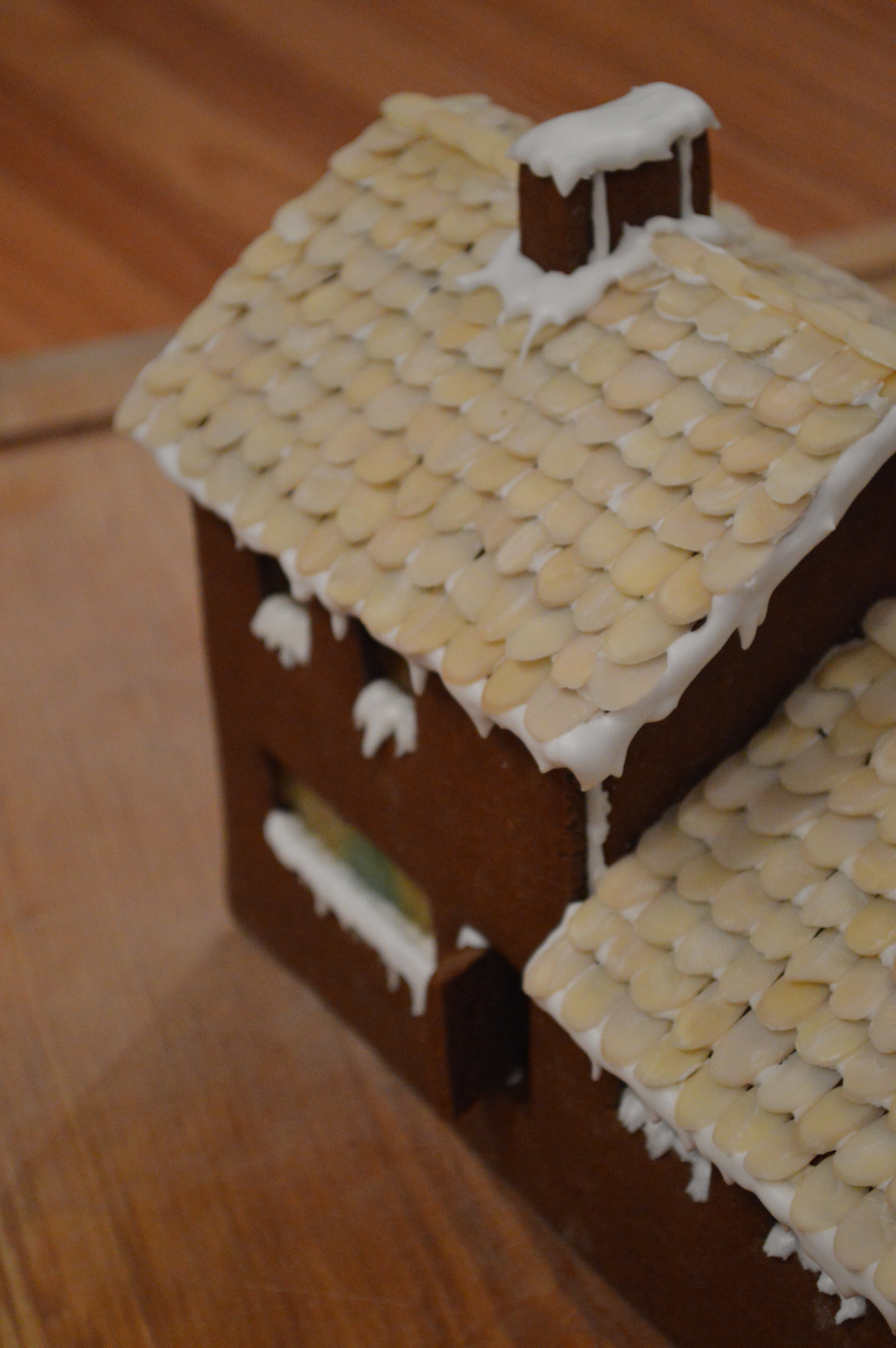 Royal icing used to mimic snow on a gingerbread house