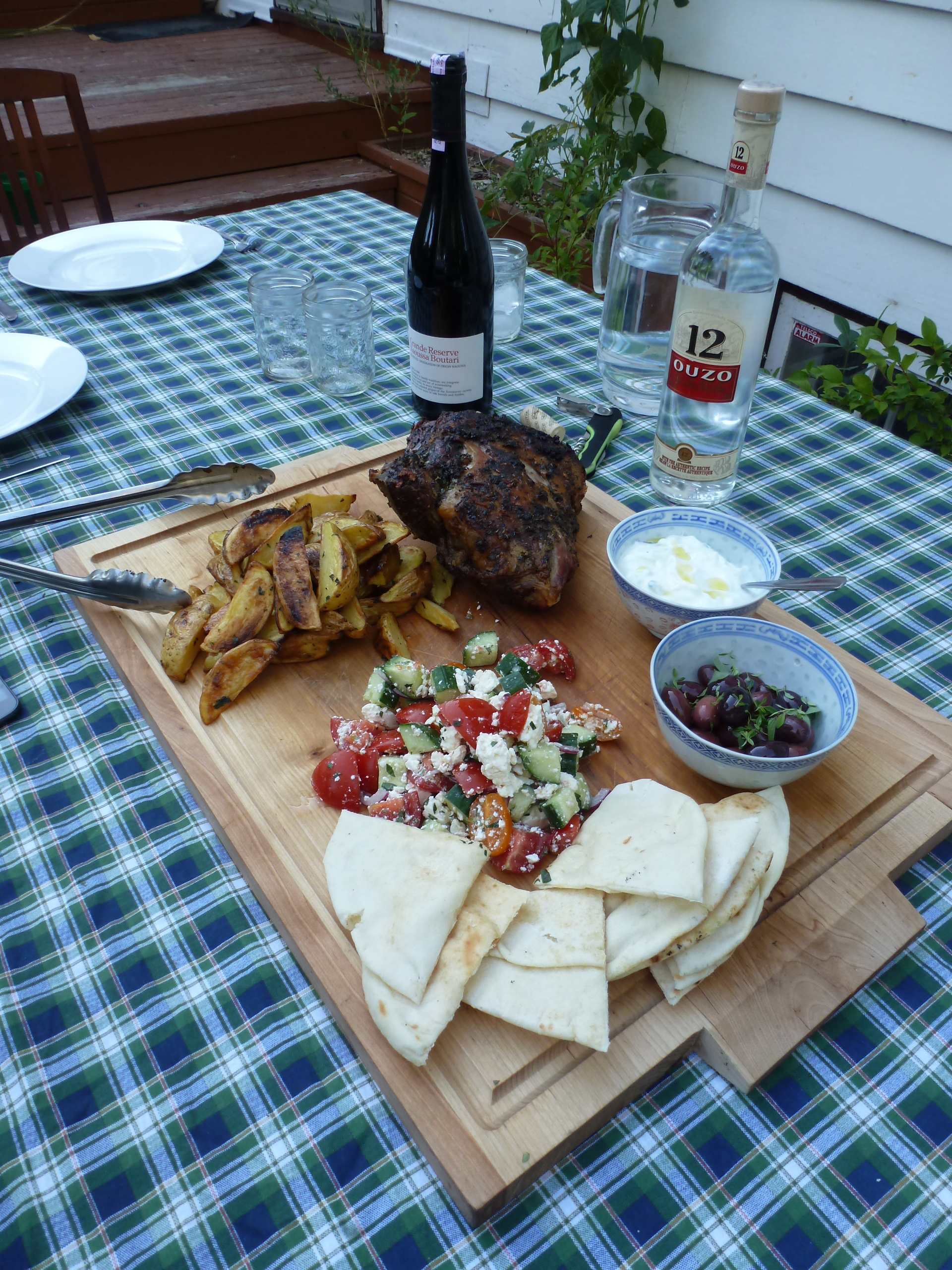 A Greek dinner for the August full moon: roast lamb shoulder, potatoes, olives, tzatziki, and horiatiki.