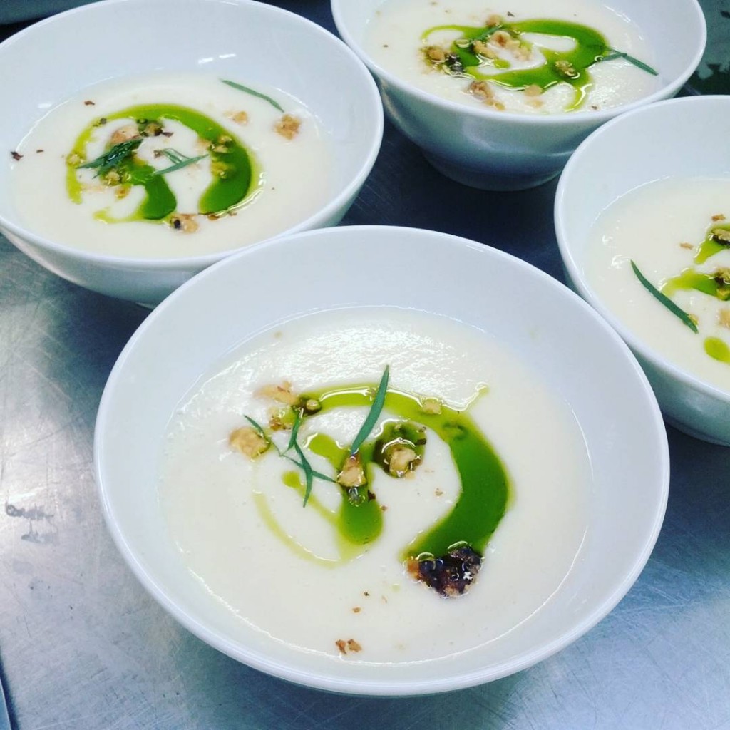 Tarragon oil floating on pear and parsnip soup