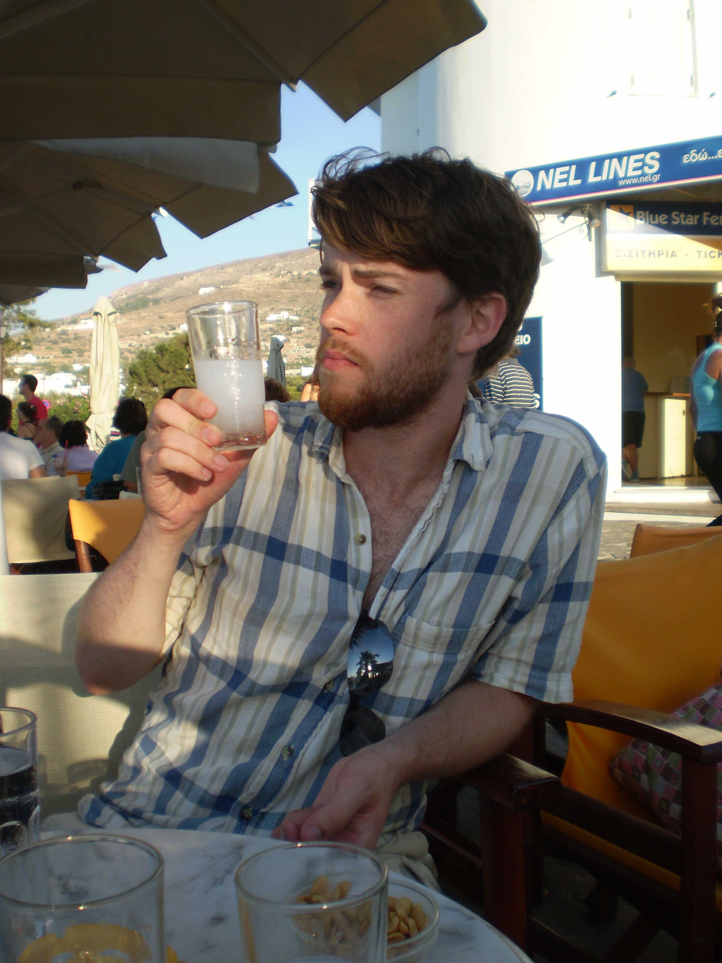 Me drinking a glass of ouzo with water in Parikia.
