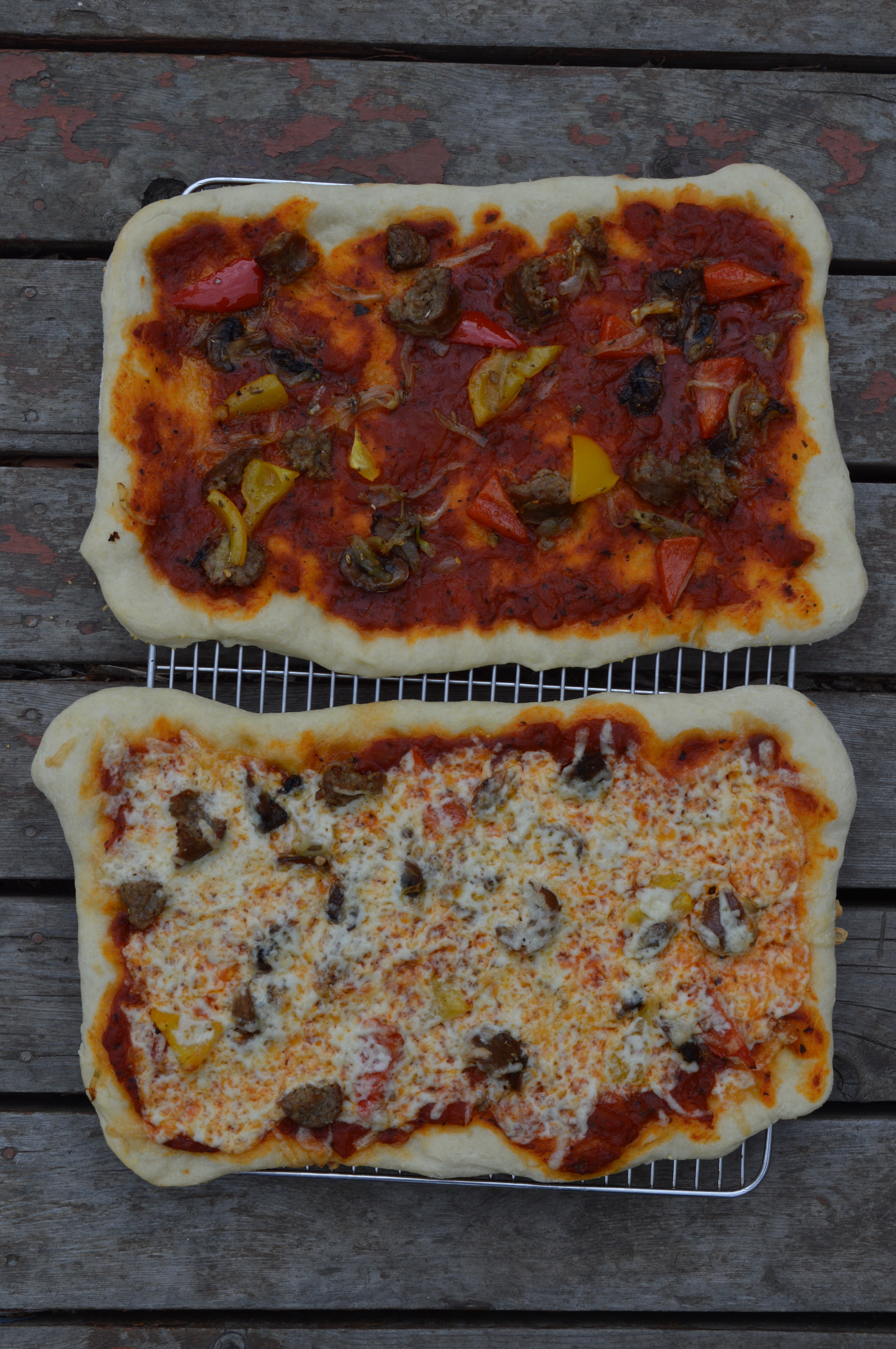 Homemade pizzas with sausage, peppers, and provolone.