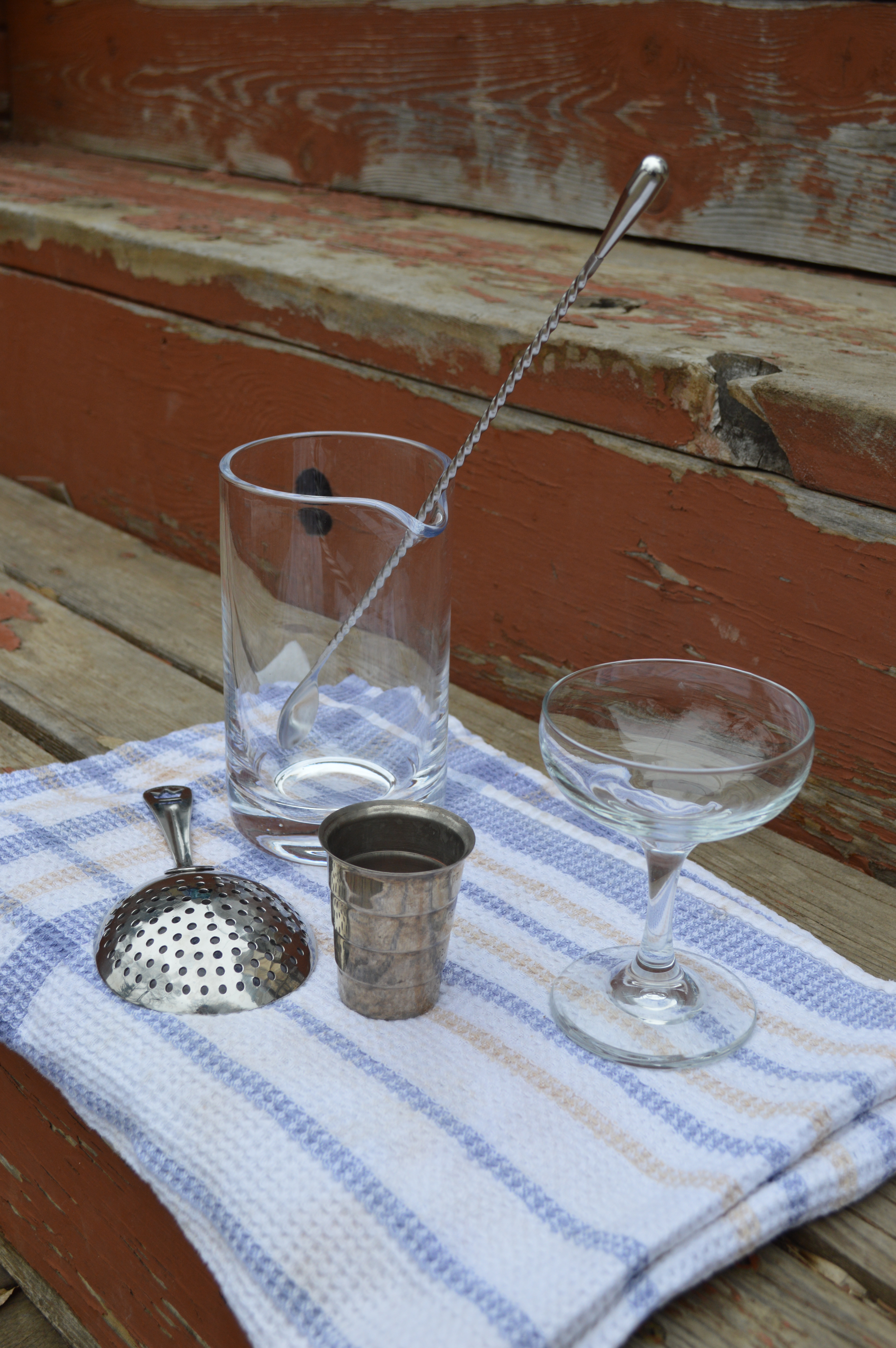 The equipment required for a stirred cocktail: mixing glass, barspoon, and julep strainer.