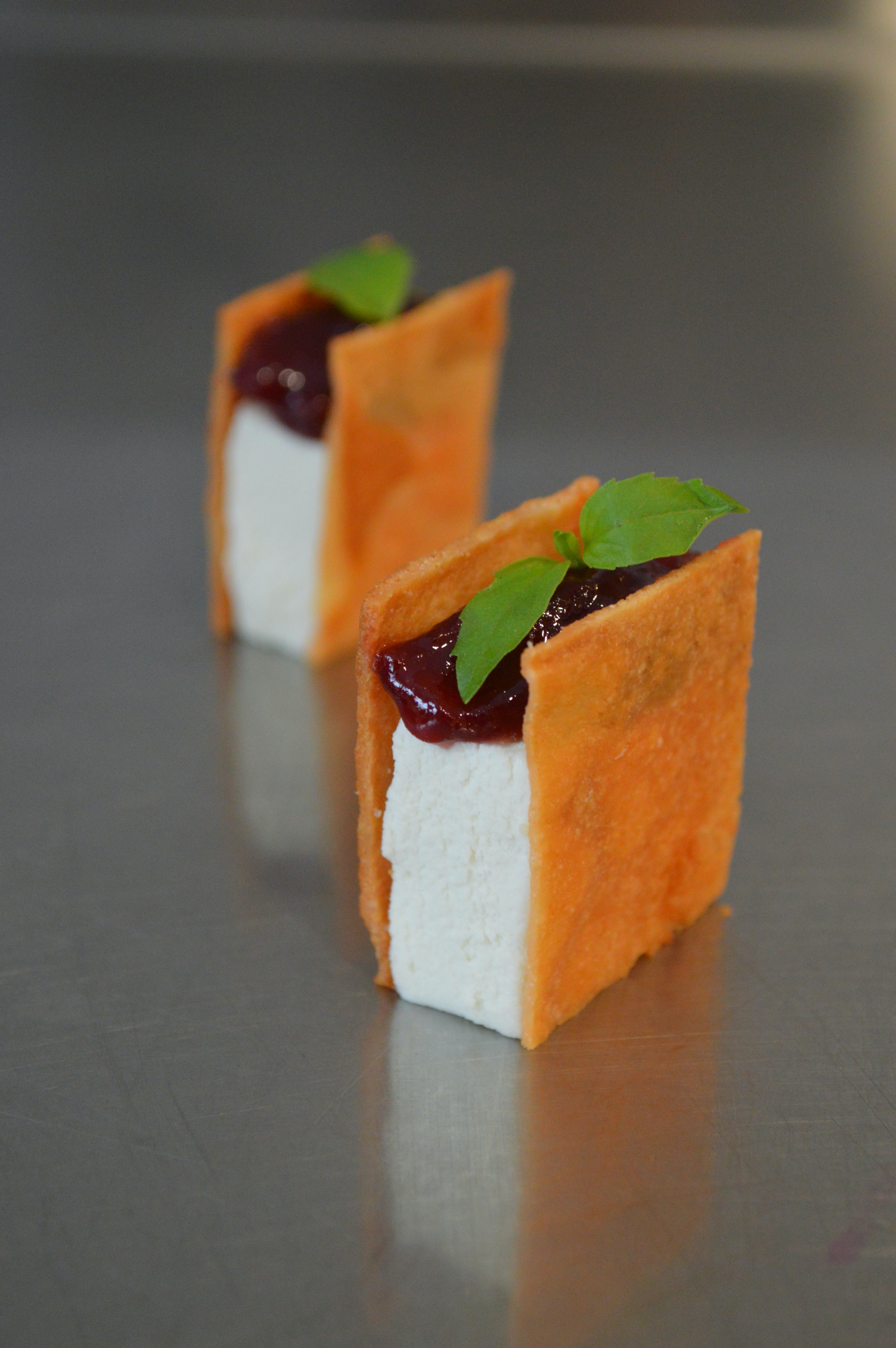 A small galette of fromage blanc, plum jam, and basil, served as an hors d'oeuvre.