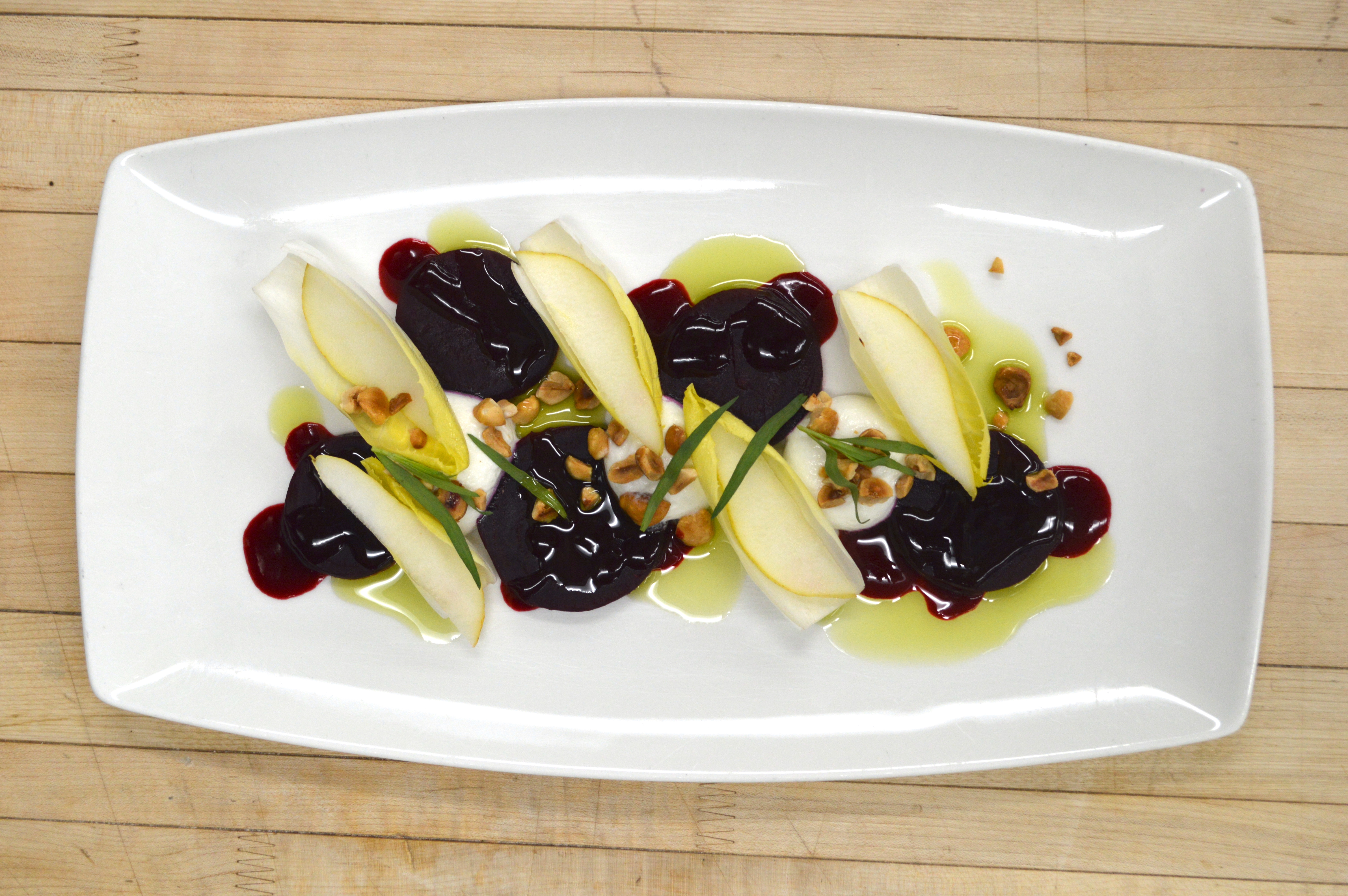 A winter beet salad with goat cheese, endive, pear, hazelnut, and tarragon.
